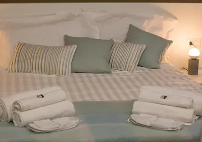 a bed with folded towels and pillows on it at Casa Malupa Luxury Apartments in Rome