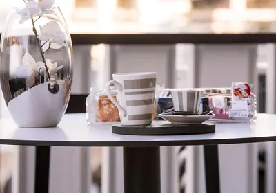 a table with coffee cups and a vase on it at Casa Malupa Luxury Apartments in Rome
