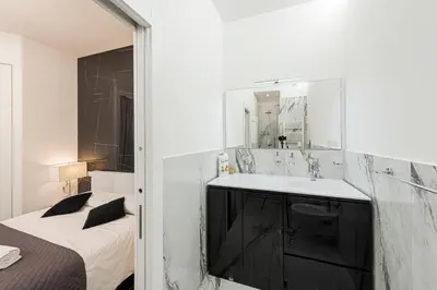 a bathroom with a sink and a bed and a mirror at Casa Malupa Luxury Apartments in Rome