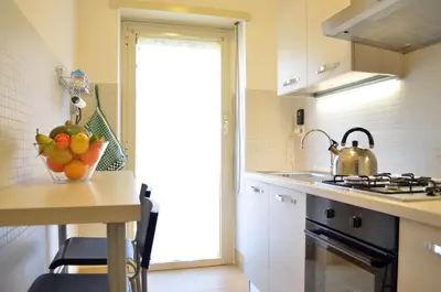 a kitchen with a bowl of fruit on a counter at Roma Caput Mundi in Rome