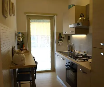 a kitchen with a sink and a stove top oven at Roma Caput Mundi in Rome