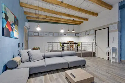 a living room with a couch and a table at Rome As You Feel - Design Apartment at Colosseum in Rome