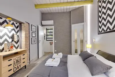 a bedroom with a large bed with towels on it at Rome As You Feel - Design Apartment at Colosseum in Rome