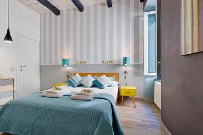 a bedroom with a large bed with pillows on it at Rome As You Feel - Design Apartment at Colosseum in Rome
