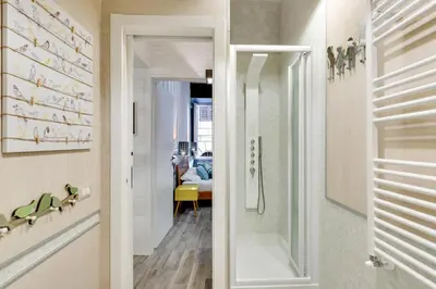 a bathroom with a shower and a walk in shower backdoor at Rome As You Feel - Design Apartment at Colosseum in Rome