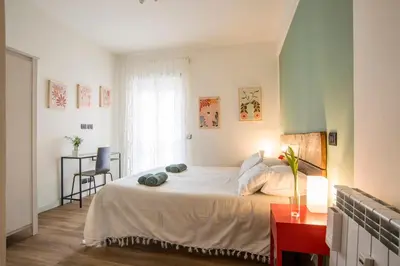 a bedroom with a bed and a table and a window at Le Stanze Di Paola in Rome