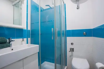 a bathroom with a shower and a toilet and a sink at Le Stanze Di Paola in Rome