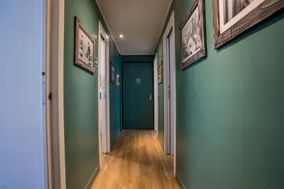 a hallway with green walls and wooden floors at Le Stanze Di Paola in Rome