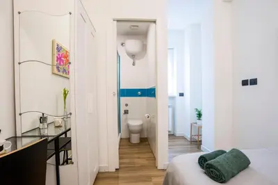 a room with a bed and a bathroom with a toilet at Le Stanze Di Paola in Rome