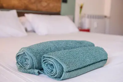 a pile of towels sitting on top of a bed at Le Stanze Di Paola in Rome
