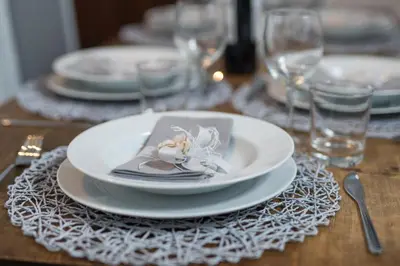 a table with a white plate with a flower on it at Sweet Campo de Fiori in Rome