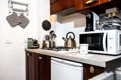 a kitchen with a microwave and a stove top oven at Sweet Campo de Fiori in Rome