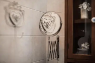 a bathroom with plates on the wall and a mirror at Sweet Campo de Fiori in Rome