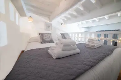 a bedroom with two beds with towels on them at Sweet Campo de Fiori in Rome