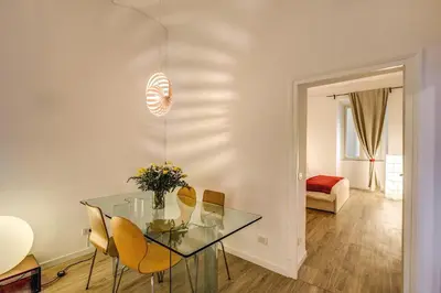 a dining room with a glass table and chairs at Vaticano casa tua in Rome