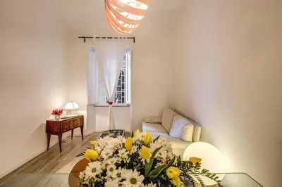 a living room with a table with flowers on it at Vaticano casa tua in Rome