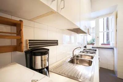 a kitchen with a sink and a stove at Passeggiata di Ripetta in Rome