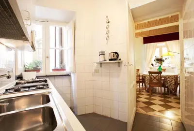 a small kitchen with a sink and a table at Passeggiata di Ripetta in Rome