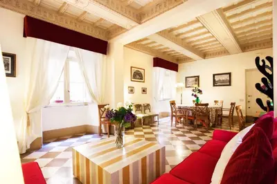 a living room with a red couch and a table at Passeggiata di Ripetta in Rome