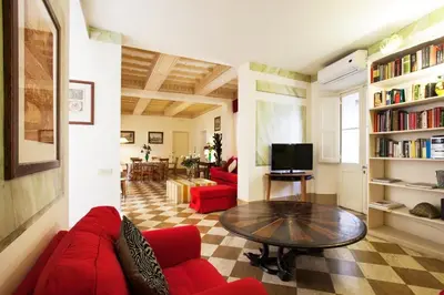 a living room with a red couch and a table at Passeggiata di Ripetta in Rome