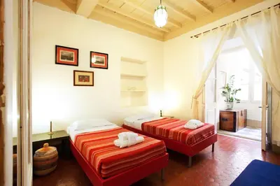 a bedroom with two beds and a window at Passeggiata di Ripetta in Rome