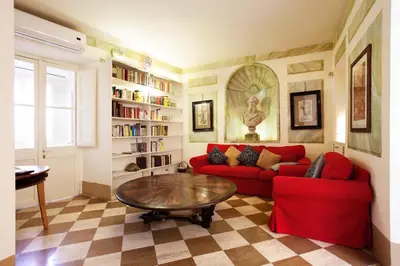 a living room with a red couch and a table at Passeggiata di Ripetta in Rome