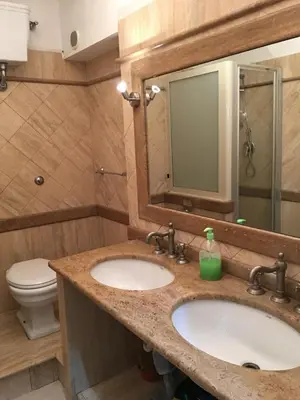 a bathroom with two sinks and a toilet at Zidan Guest House in Rome