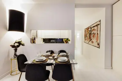 a dining room with a table and chairs and a kitchen at Luxury Apartment Casa Farnese – Campo de Fiori in Rome