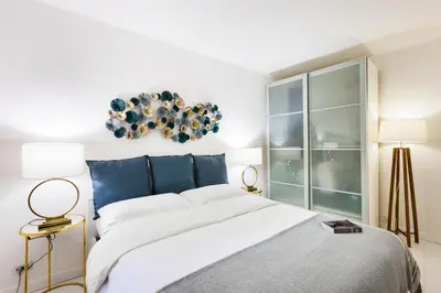 a bedroom with a large bed and two lamps at Luxury Apartment Casa Farnese – Campo de Fiori in Rome