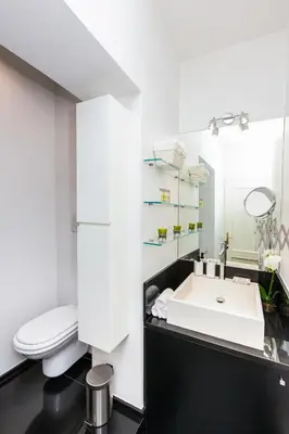 a bathroom with a white toilet and a sink at Luxury Apartment Casa Farnese – Campo de Fiori in Rome