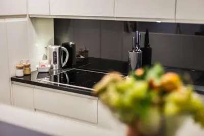 a kitchen with a stove and a counter top at Luxury Apartment Casa Farnese – Campo de Fiori in Rome