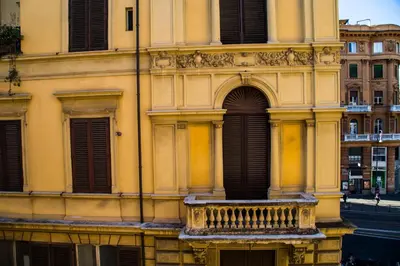 a building with a balcony on a street at Argentina Exclusive Apartment in Rome