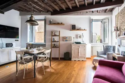 a living room with a table and chairs and a couch at AndreaSuite - Piazza Navona in Rome