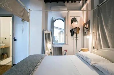 a bedroom with a bed and a window at AndreaSuite - Piazza Navona in Rome