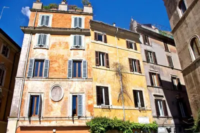 an old building with a clock on top of it at AndreaSuite - Piazza Navona in Rome