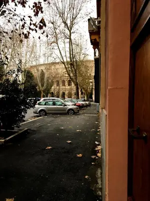 a street with cars parked in a parking lot at Dolce Casa Colosseo in Rome