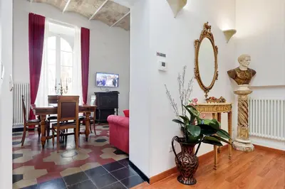 a living room with a table and a mirror at Dolce Casa Colosseo in Rome