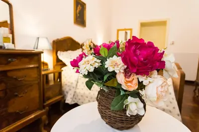 a vase of flowers sitting on top of a table at A Casa Cibella in Rome