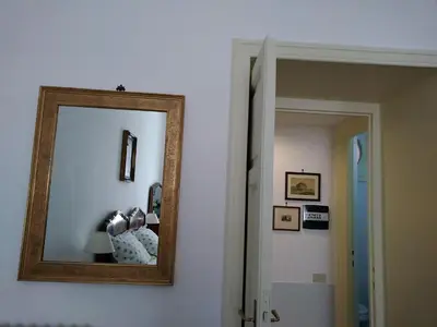 a mirror hanging on a wall in a room at A Casa Cibella in Rome