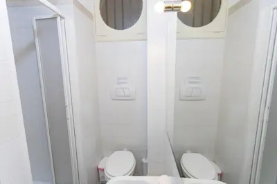 a white bathroom with a toilet and a sink at A Casa Cibella in Rome