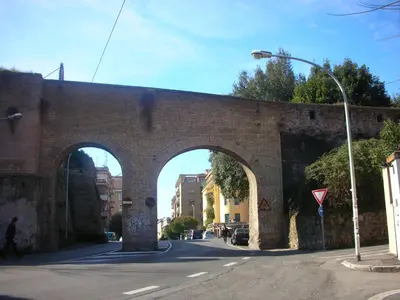 an old brick bridge with two arches on a street at A Casa Cibella in Rome