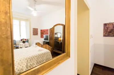 a mirror in a room with a bed and a table at A Casa Cibella in Rome