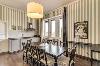 a kitchen and dining room with a table and chairs at DOWNTOWN SRL - Imperial Panorama Penthouse in Rome