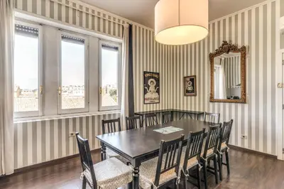 a dining room with a table and chairs and a mirror at DOWNTOWN SRL - Imperial Panorama Penthouse in Rome