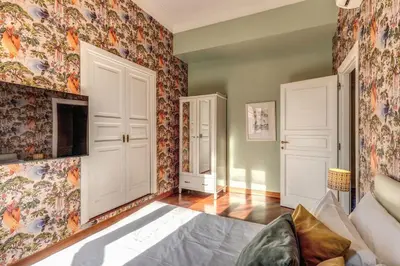 a bedroom with floral wallpaper on the walls at DOWNTOWN SRL - Imperial Panorama Penthouse in Rome