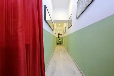 a hallway with a red curtain and a wooden floor at Lucky Holiday Rooms in Rome