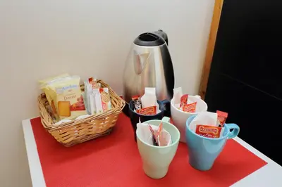 a counter with two cups and a coffee maker at Lucky Holiday Rooms in Rome