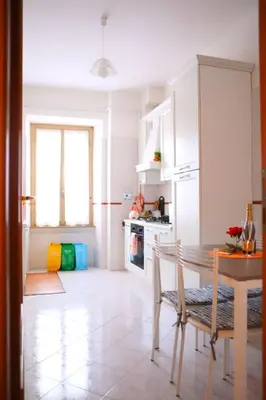 a kitchen with a table and a dining room at Linda Musei Vaticani in Rome