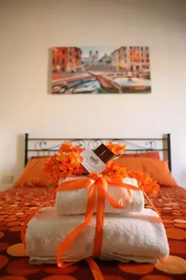a pile of towels on a bed with an orange ribbon at Linda Musei Vaticani in Rome