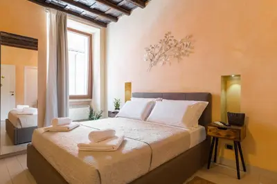 a bedroom with a bed with two towels on it at TrinitaDeiMonti Guest House in Rome